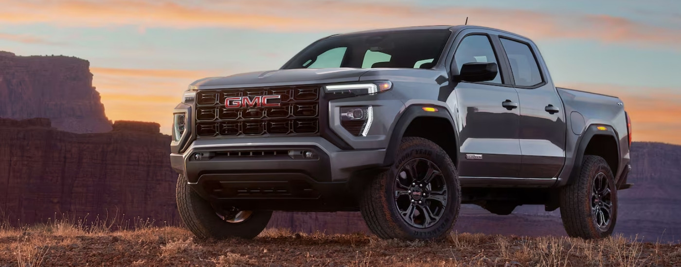 A silver 2023 GMC Canyon Elevation parked off-road.