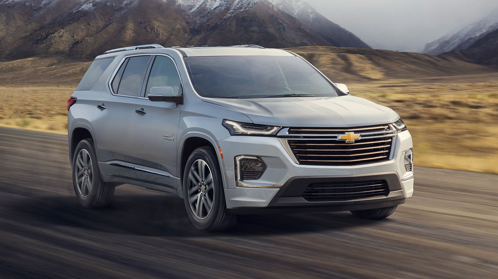 A silver 2022 Chevrolet Traverse driving on the road. 