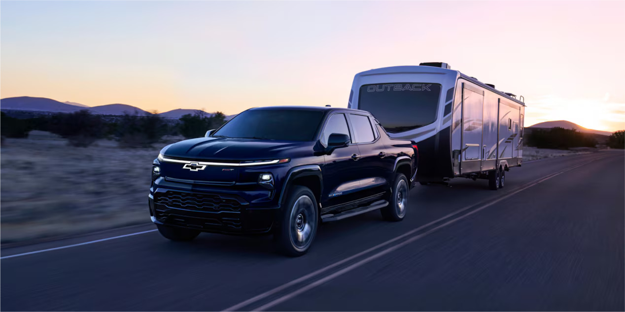 A 2024 Chevrolet Silverado EV pulling a mobile home.