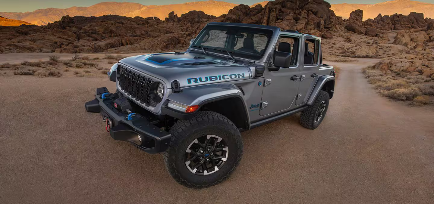 A gray 2024 Jeep Wrangler 4xe parked in the desert.