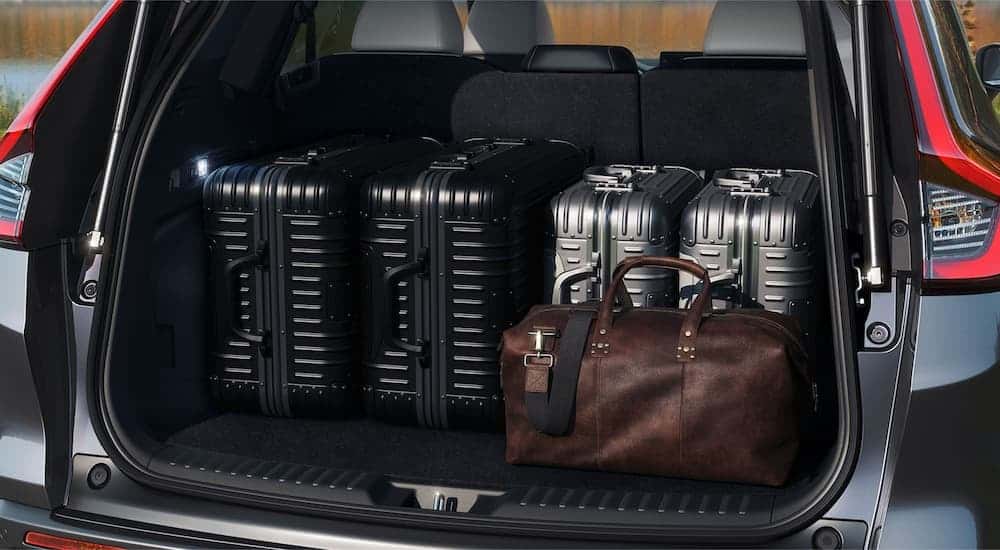 The rear cargo storage in a black 2025 Honda CR-V Hybrid for sale near Henrietta.