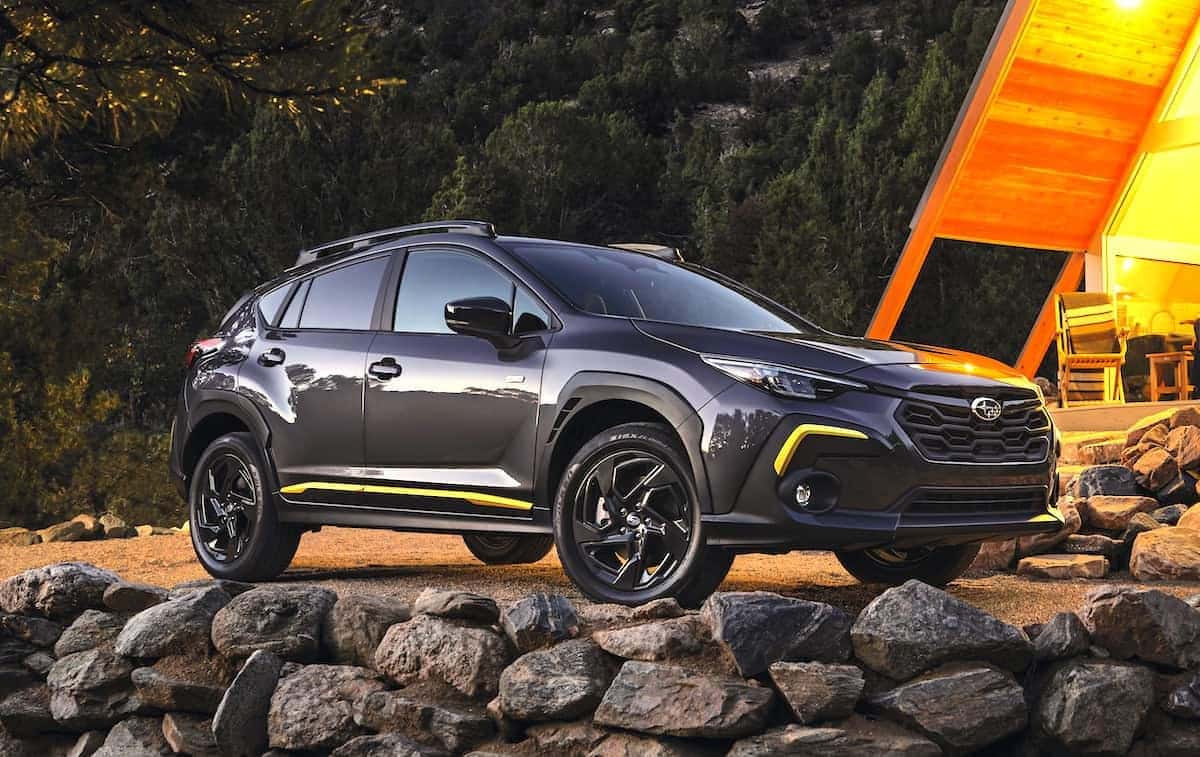 Gray 2024 Subaru Crosstrek with yellow accents parked on rocks