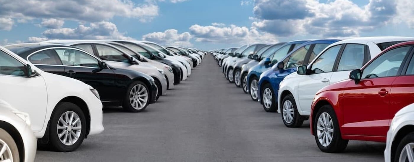 Many cars on a car lot.