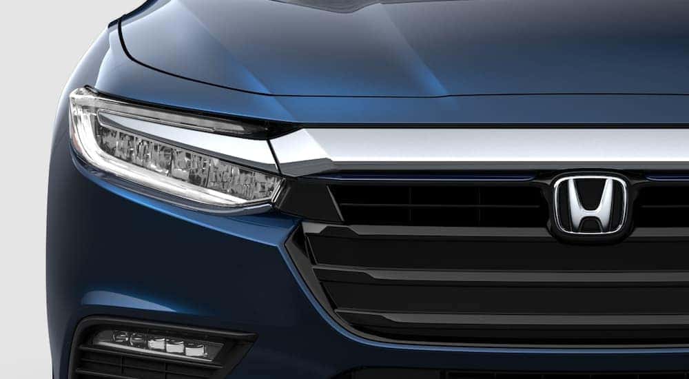 Close-up on headlight of a blue 2021 Honda Insight.
