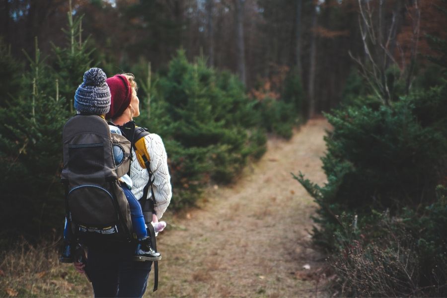 Mom holding baby on carrier while hiking