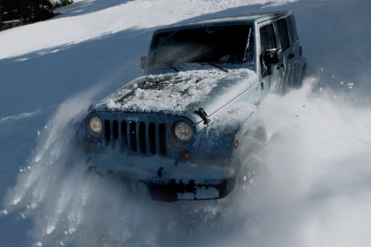 2012 Jeep Wrangler Exterior Driver Side Front Angle Driving in Deep Snow