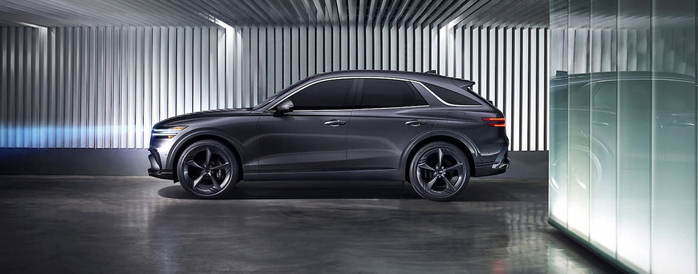 Side of a grey 2021 Genesis GV70 parked in a building.