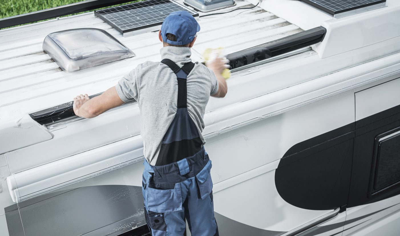 Kunes RV technician treating the roof of a RV