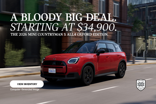 Red MINI Countryman Oxford driving down the road.