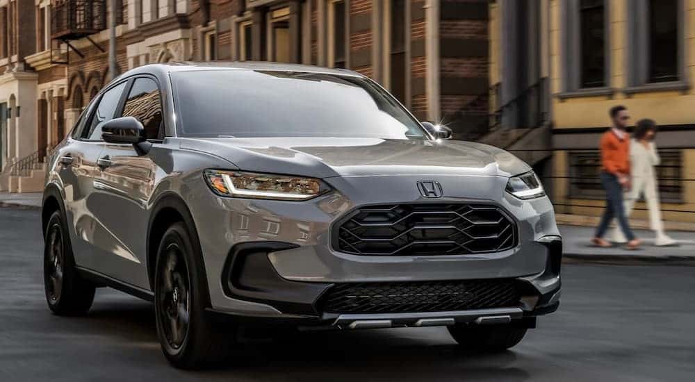 A silver 2025 Honda HR-V Sport is shown driving after viewing a Honda HR-V for sale near Medina.