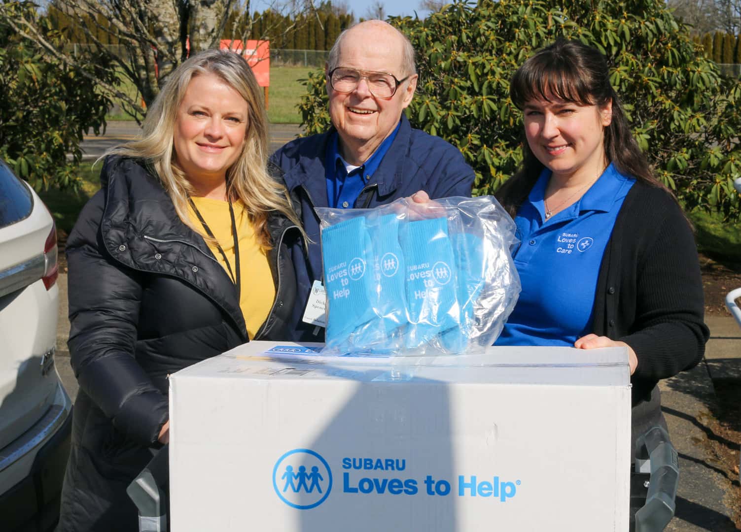 Wilsonville Subaru staff donating socks in a Subaru Loves to Help box