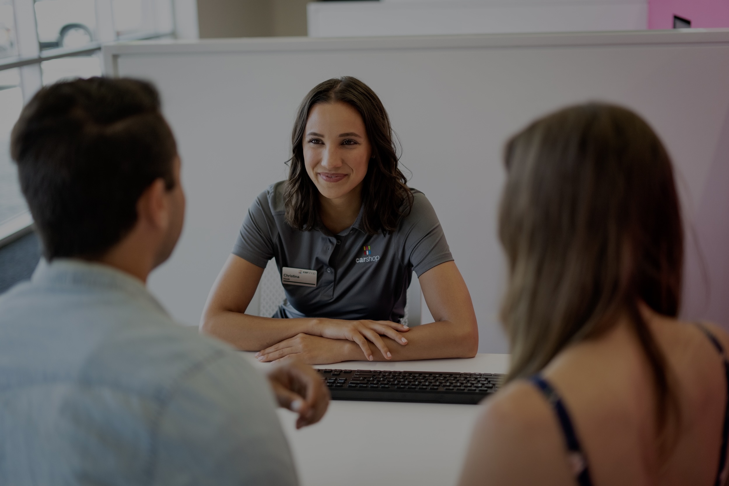 Associate smiling with two clients