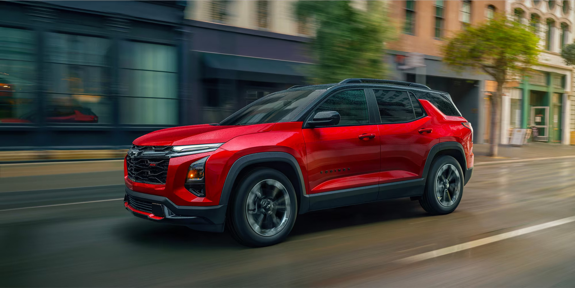 A red suv driving on the road.