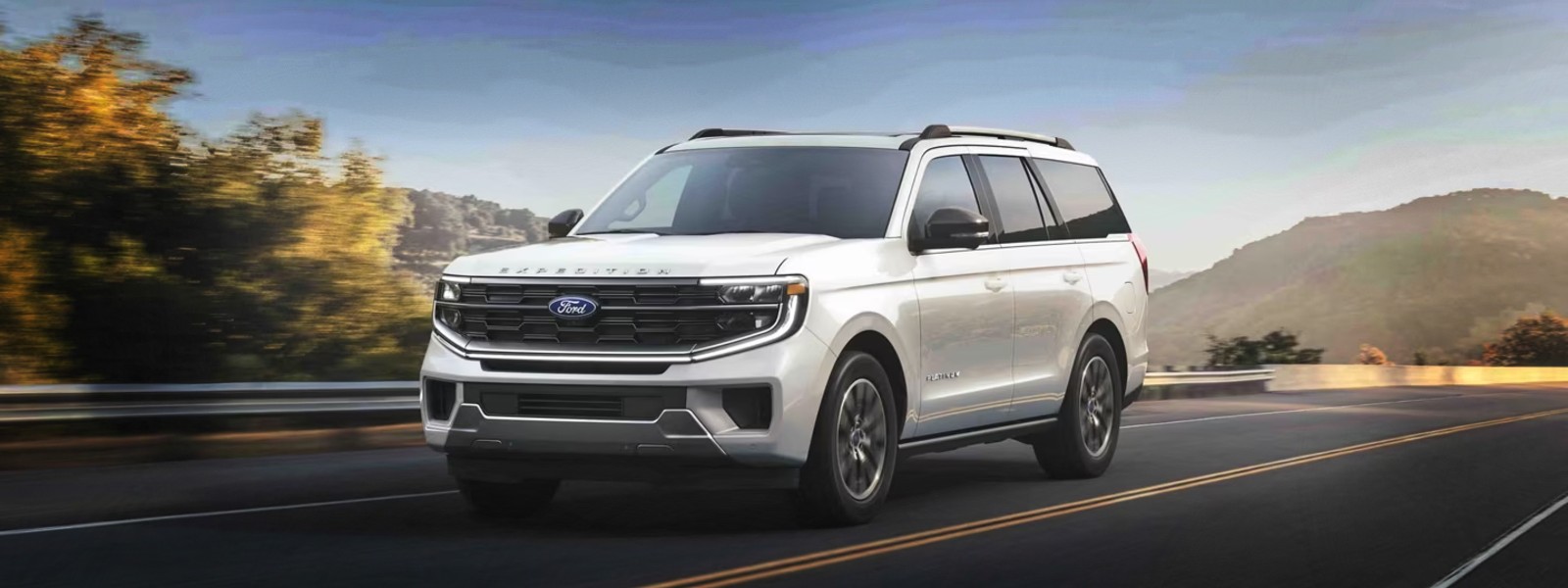 White Ford Expedition driving on the highway