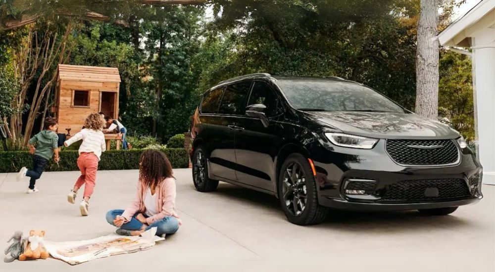 A grey 2023 Chrysler Pacifica is shown from the front at an angle.