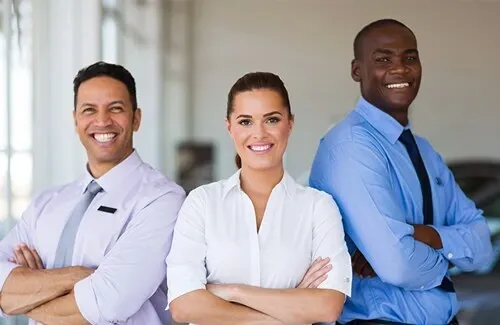 Three smiling McGovern Auto Group sales specialists