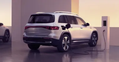 Exterior shot of a vehicle charging at a charging station