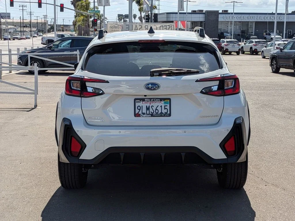 Rear of the white used 2024 Subaru Crosstrek Premium showing the Crosstrek and AWD badges, at Dalton Subaru National City used-car super-center