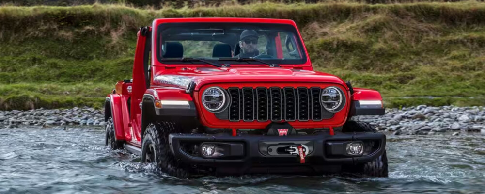 2024 Jeep Wrangler driving through a river