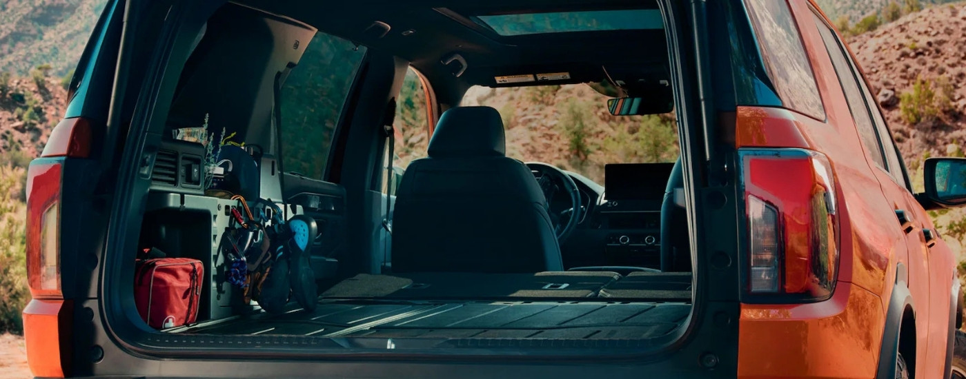 Cargo area is shown in an orange 2026 Honda Passport TrailSport Elite