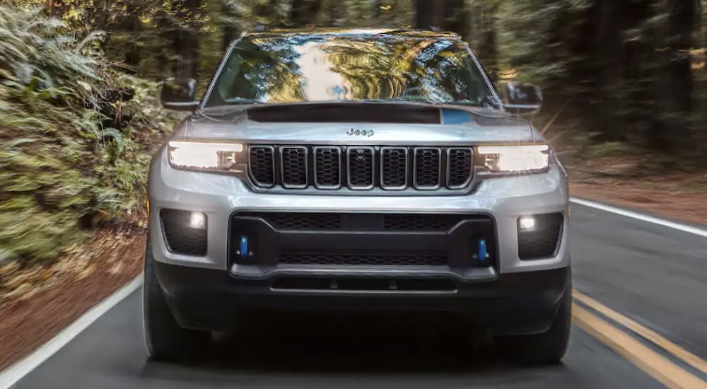 Front grille view of a 2023 Jeep Grand Cherokee 4xe driving.