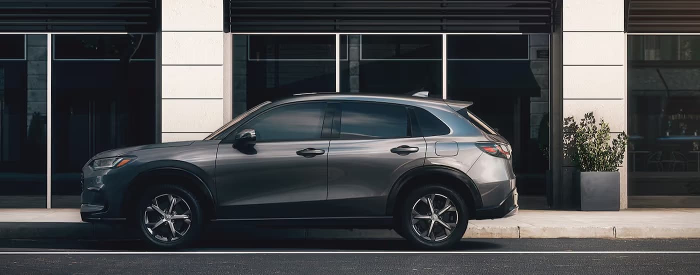 A silver 2025 Honda HR-V parked in a city.