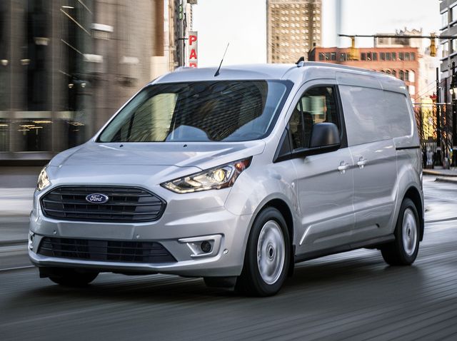 a Ford Transit Connect driving through a city street