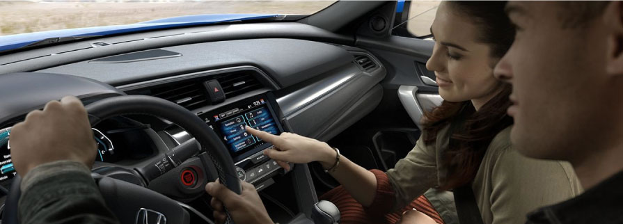 Person using infotainment screen in a 2017 Honda Civic