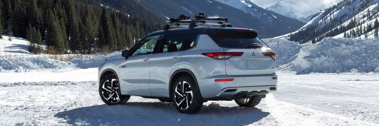 Rear view of a Mitsubishi Outlander PHEV in a snowy environment