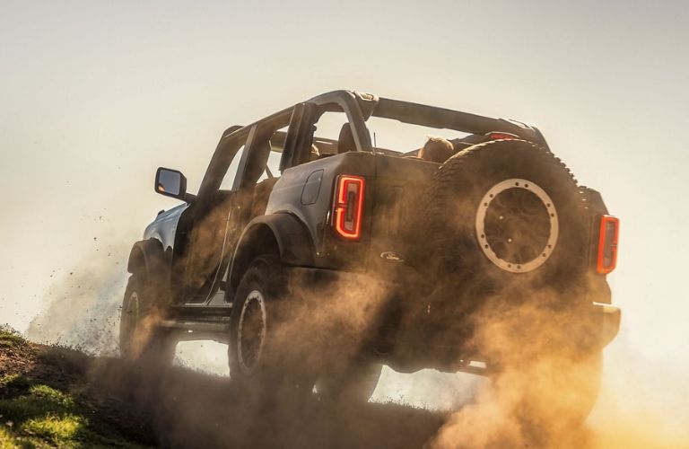 Black 2024 Ford Bronco Rear Kicking Up Sand on the Trail