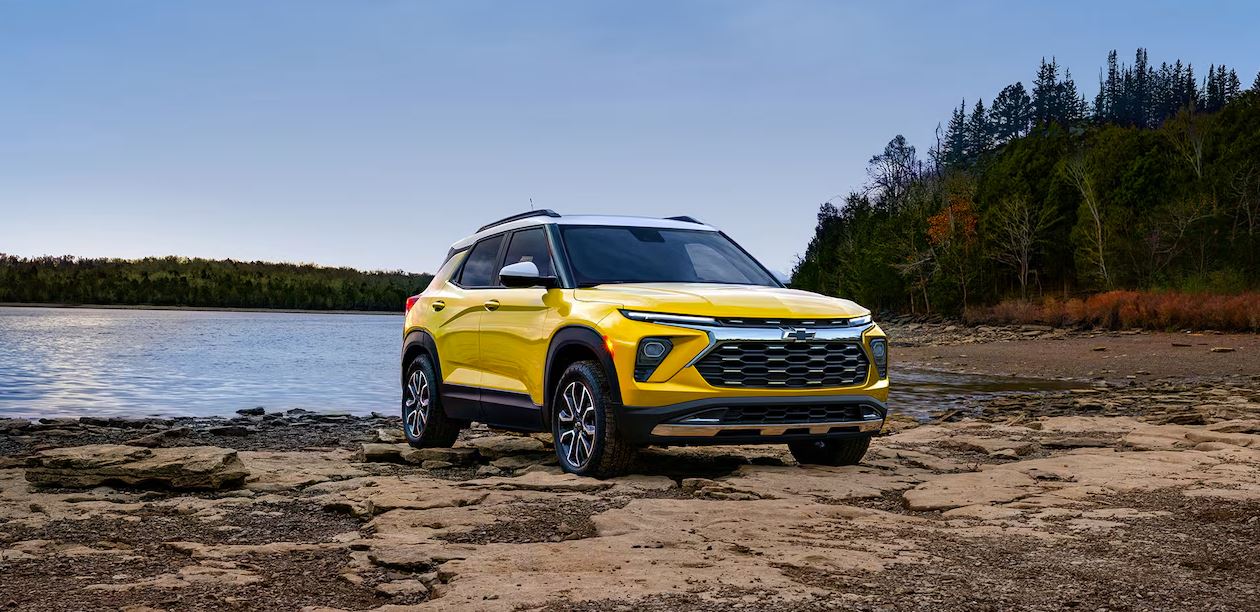 2024 Chevrolet Trailblazer in vibrant blue driving through a modern urban city, showcasing its sleek design and dynamic performance.