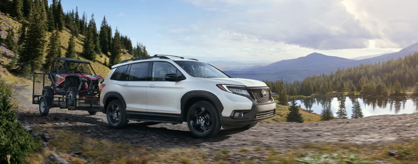 White 2020 Honda Passport Elite is towing a trailer