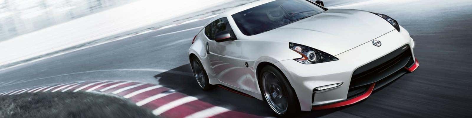White Nissan 370Z NISMO cornering on a race track