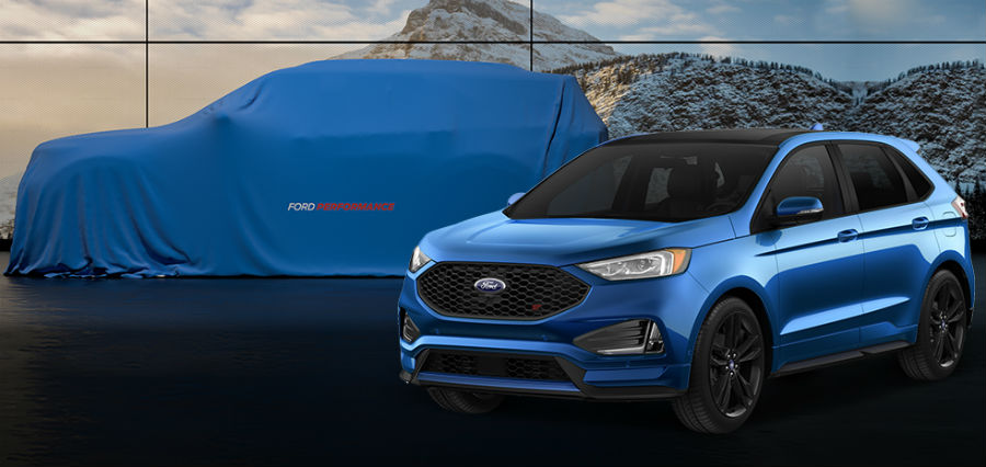 side view of a blue 2019 Ford Edge ST with a covered all-new Ford Explorer ST in the back