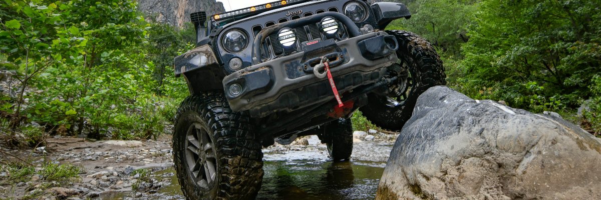 Black Lifted Jeep Rock Crawling