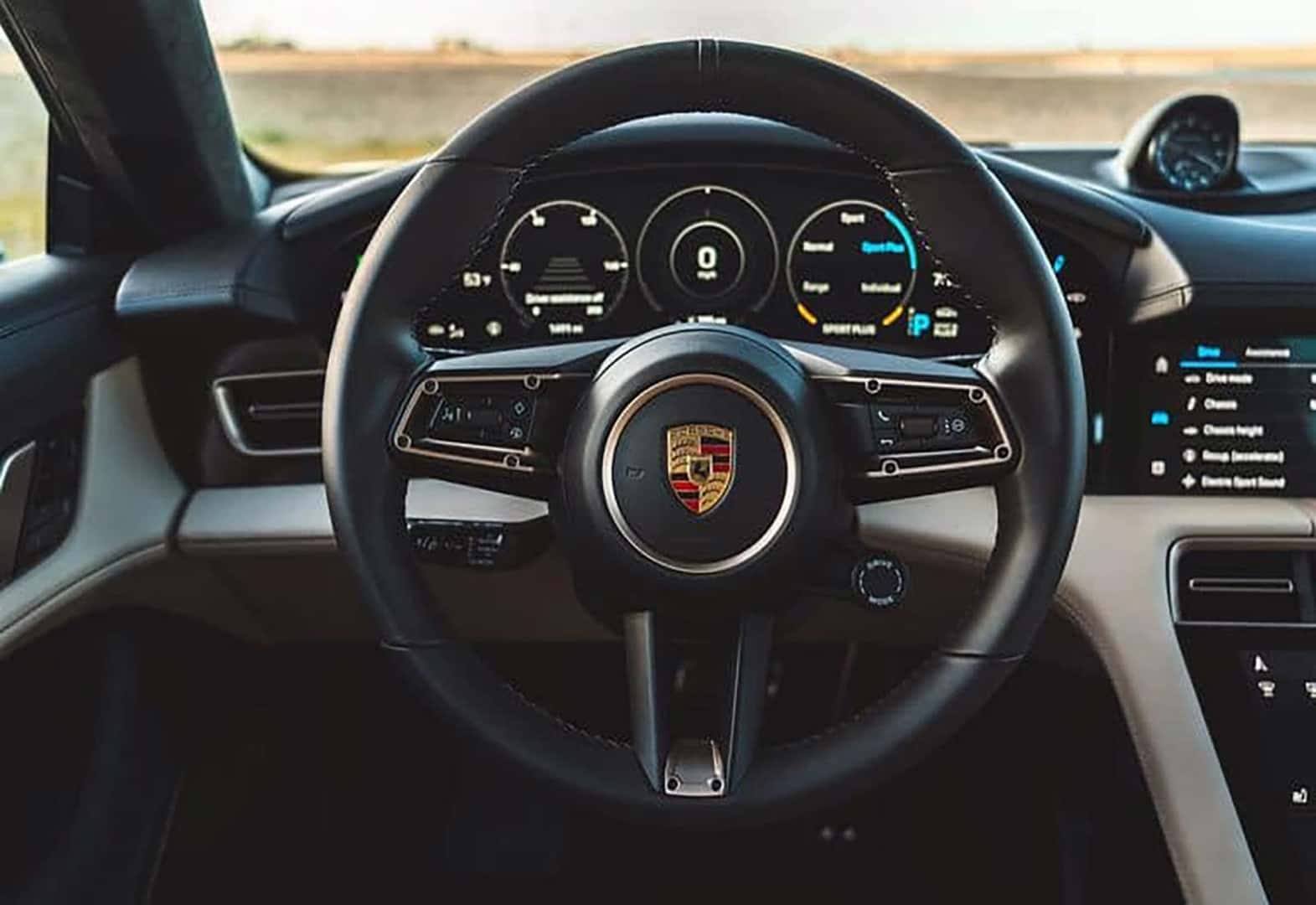 The steering wheel and front dash of the Porsche Taycan 4 Cross Turismo Luxury Electric Vehicle