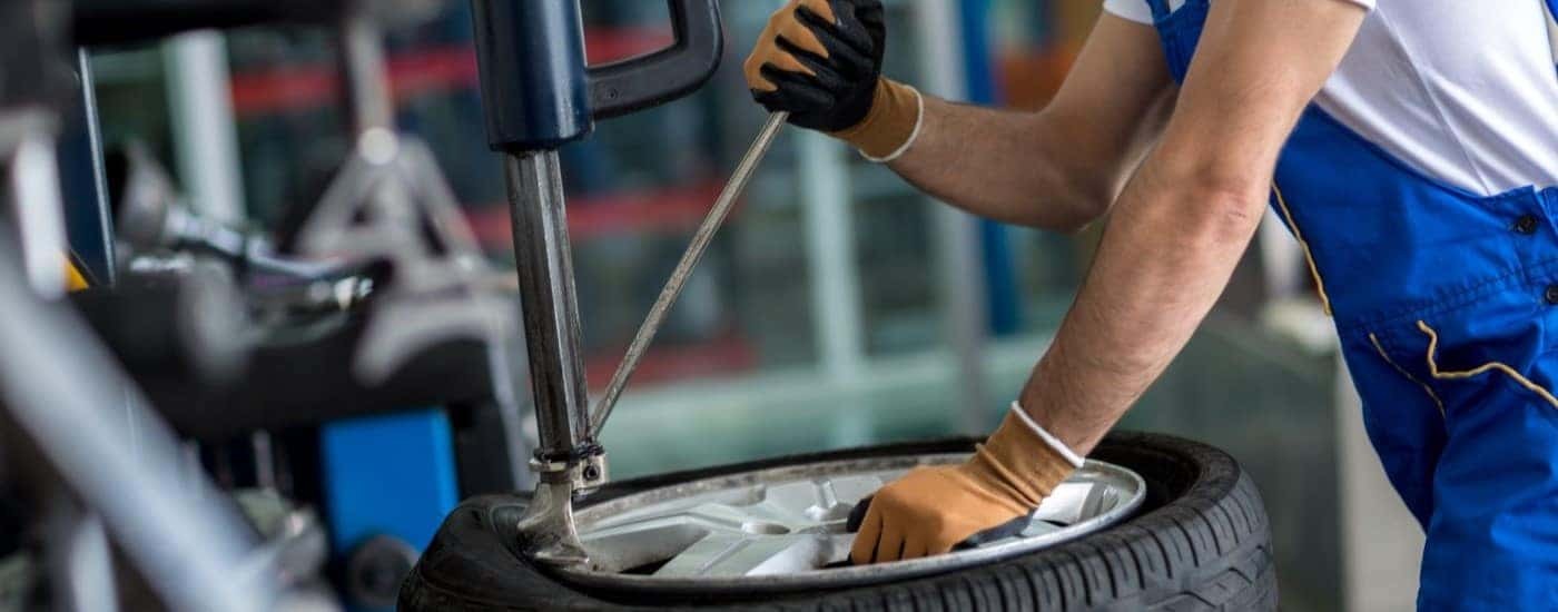 Mechanic removing a tire from a rim at a shop