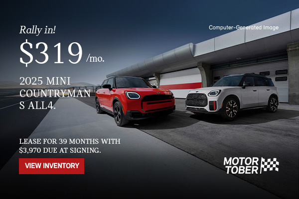 2 MINI Countryman ALL4s front and side views parked in front of a garage.  