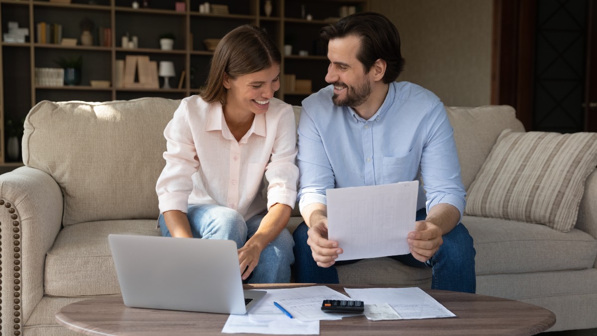 Happy Couple Signing Renter's Insurance Agreement