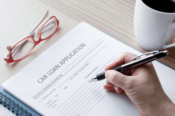 Person filling out a car loan application