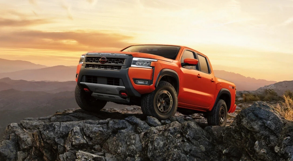 Orange 2025 Nissan Frontier PRO-4X for sale parked off-road