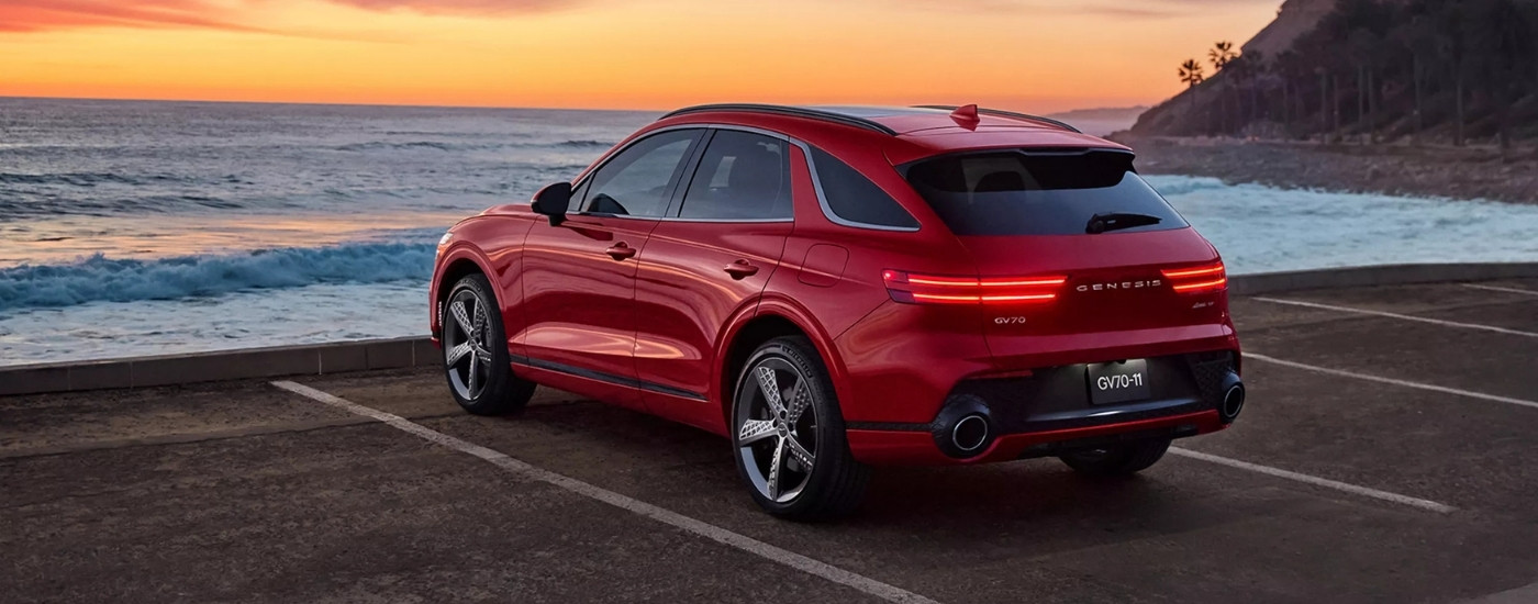 Red 2024 Genesis GV70 parked on a shore