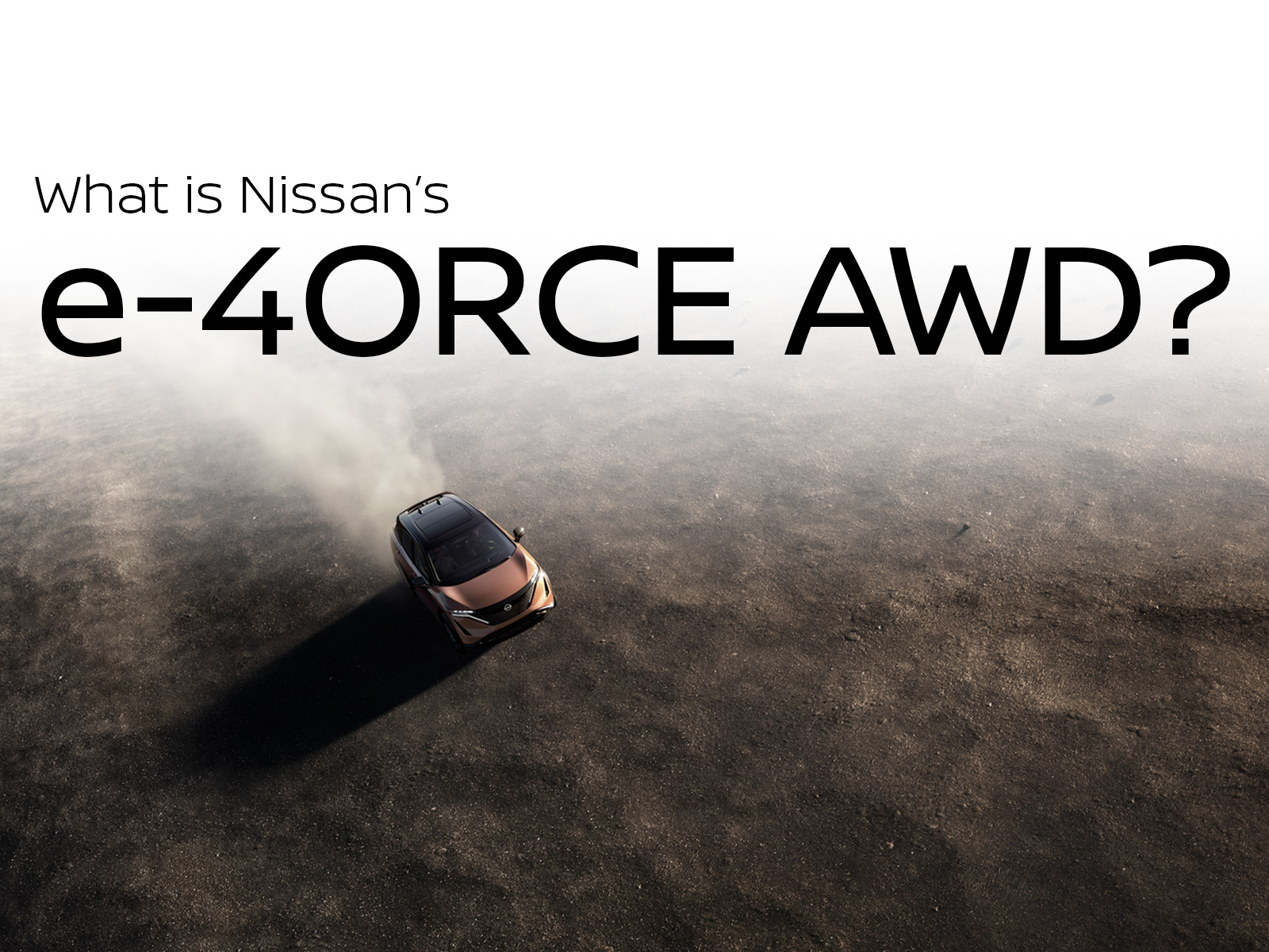 Aerial view of a Nissan ARIYA driving on dirt, showcasing Nissan’s e-4ORCE all-wheel drive performance in rugged conditions
