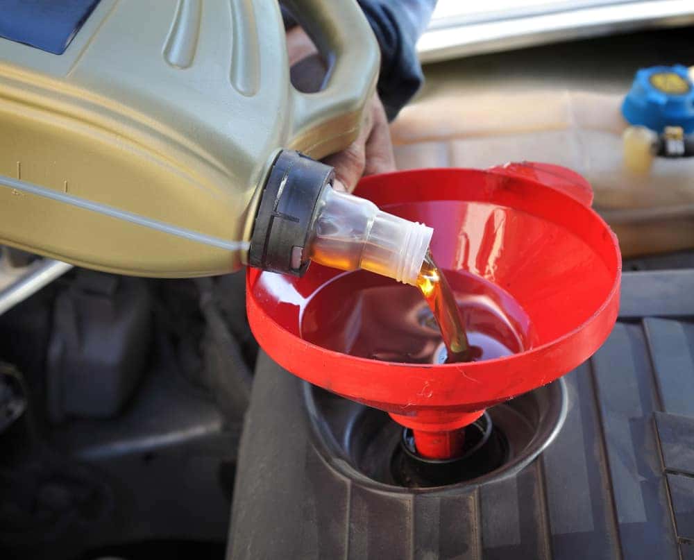Pouring oil into a funnel
