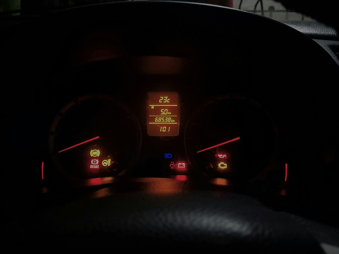 a dashboard of a car with warning lights