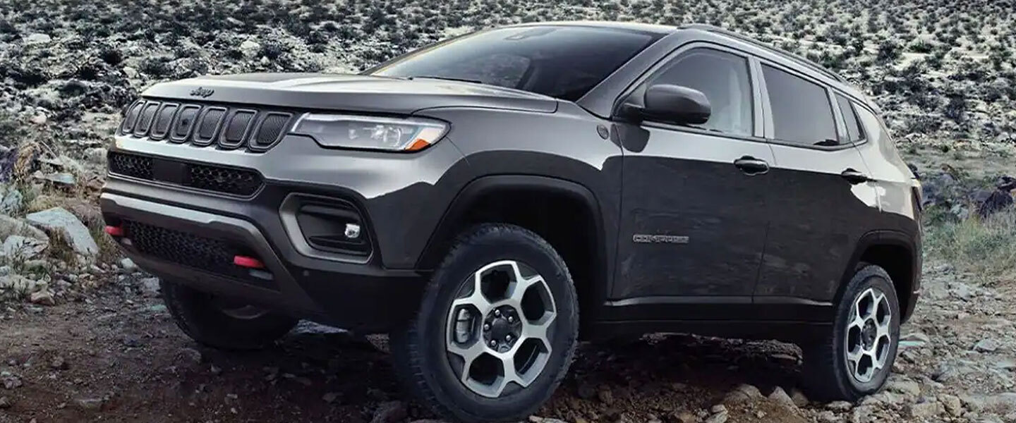 The 2022 Jeep Compass parked on a dirt trail.