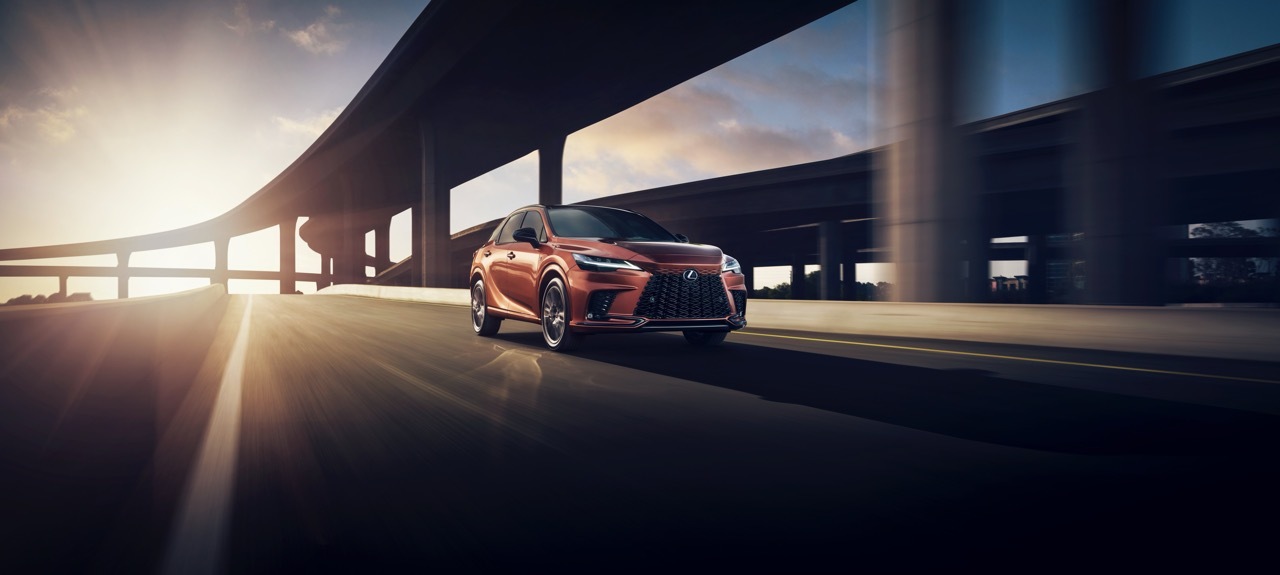RX F SPORT Handling in Copper Crest driving through city streets.