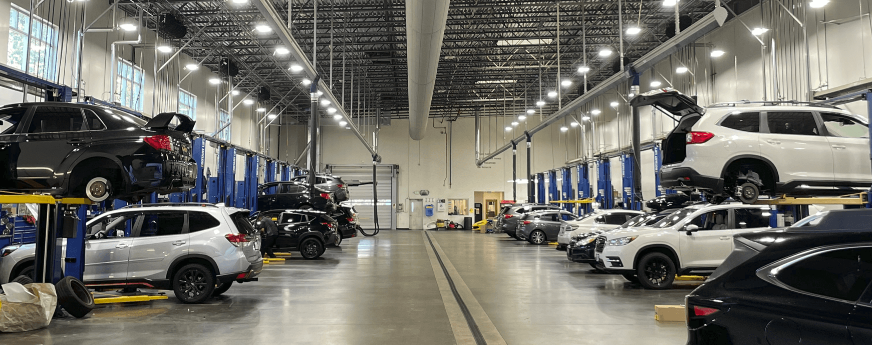 Wilsonville Subaru service bays with vehicles on lifts