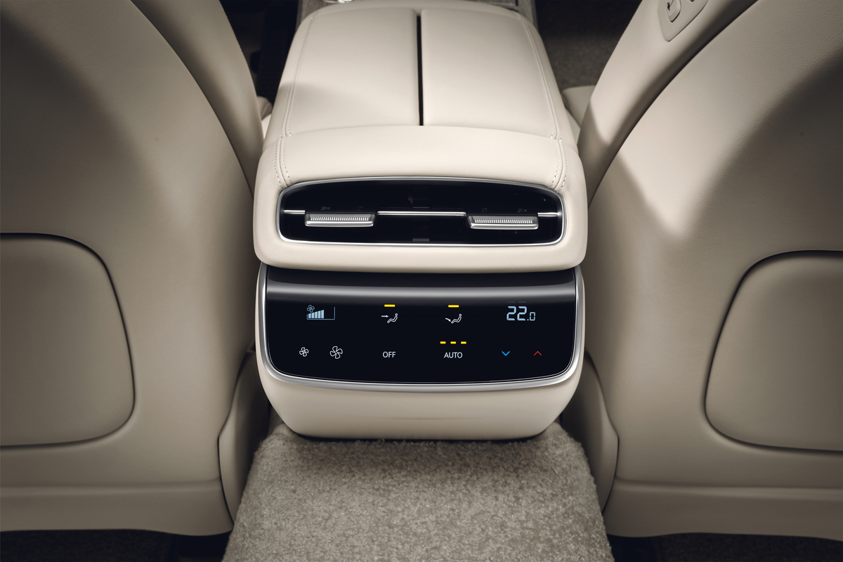 Interior closeup from rear seat pov of climate control display on center console inside Genesis G80