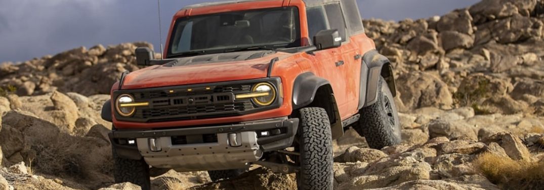 Orange 2023 Ford Bronco Raptor on a Rocky Trail